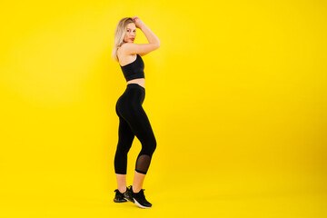 Fototapeta na wymiar Young woman, posing in the studio. Advertising sportswear and yoga wear. Healthy lifestyle, sport