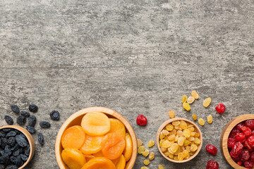 Bowl with different dried fruits on table background, top view. Healthy lifestyle with copy space