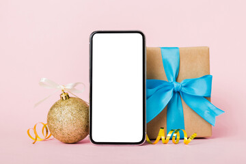 Digital phone mock up with rustic Christmas decorations for app presentation with empty space for you design. Christmas online shopping concept. Tablet with copy space on colored background