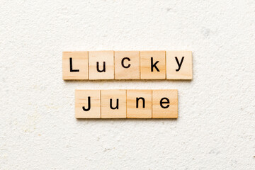 lucky June word written on wood block. Happy June text on table, concept