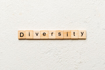 Diversity word written on wood block. Diversity text on cement table for your desing, concept