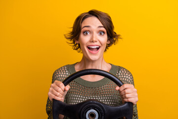Photo portrait of lovely young lady hold excited steering wheel wear trendy knitwear khaki garment...