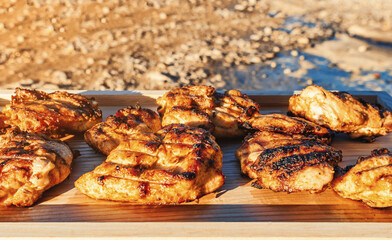 Sun-Kissed Grilled Chicken Cuts on Wooden Presentation. An Artful Display of Culinary Brilliance