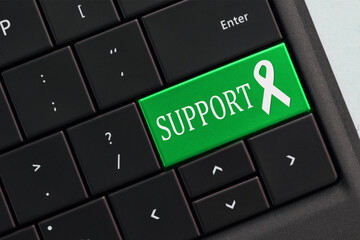Online help Support Concept - keyboard with GREEN support awareness ribbon key button.