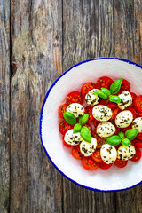 Caprese salad on wooden background
