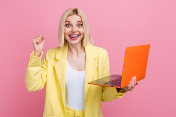Photo of cute lucky lady wear yellow jacket suit texting emails modern device rising fist isolated pink color background