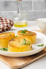 Soft potato fondant sprinkled with herbs, vertical photo.