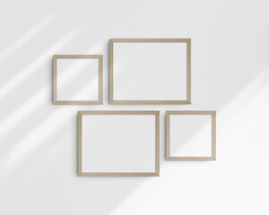 Gallery wall mockup set, 4 birch wooden frames. Clean, modern, and minimalist frame mockup. Two horizontal frames and two square frames, 14x11 (14:11), 8x8 (1:1) inches. White wall with shadows.