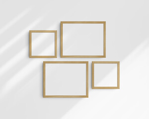 Gallery wall mockup set, 4 timber oak wood frames. Clean, modern, and minimalist frame mockup. Two horizontal frames and two square frames, 14x11 (14:11), 8x8 (1:1) inches. White wall with shadows.