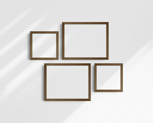 Gallery wall mockup set, 4 brown walnut wood frames. Clean, modern, and minimalist frame mockup. Two horizontal frames and two square frames, 14x11 (14:11), 8x8 (1:1) inches. White wall with shadows.