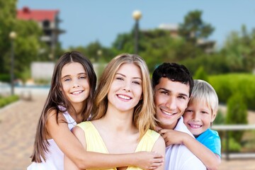 Happy young family in the city garden