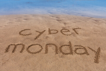 Cyber Monday text written in the sand on the beach.