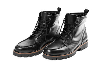 Pair of black leather boots, dress boots for men, men ankle high boots. Black brogue boots on a white background. Men fashion in leather boots. Man's legs in black jeans and brown leather boots.