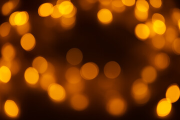 Abstract background, orange bokeh on a black background.
