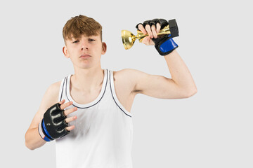 Teenage boxer boy with a trophy