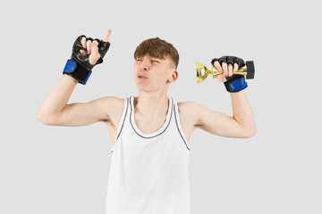 Teenage boxer boy with a trophy