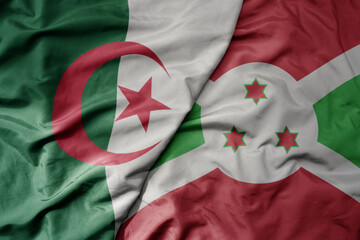 big waving national colorful flag of algeria and national flag of burundi .