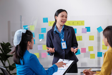 Business, board and Asian woman with presentation, planning and explain process at a workshop. Female person, presenter and speaker writing, brainstorming and motivation with profit growth and mentor