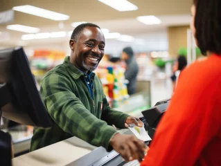 Fotobehang A happy supermarket cashier at work © kalafoto