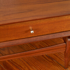 Mid-Century Modern coffee table. Vintage walnut furniture. Close-up detail photograph.