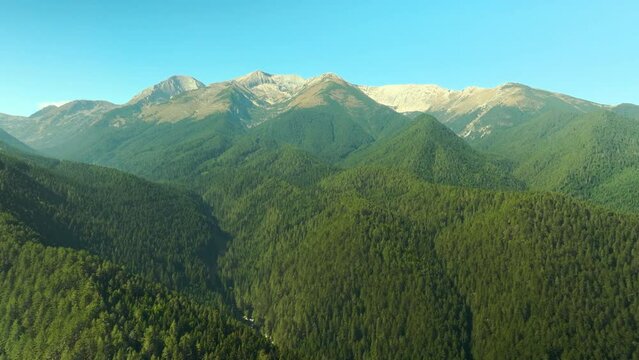 Aerial video over Pirin mountains, moving towards the tallest peaks: Vihren, Kotelo and others.