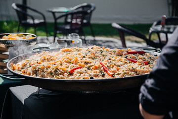 Traditional homemade Iranian pilaf in large metal bowl at street market