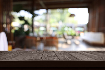 Empty wooden table in cafe, blurred interior. Space for design