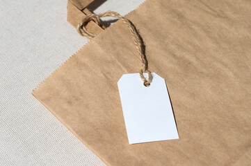 The concept of eco-friendly packaging. Part of a package with a white tag on a rope with handles