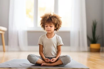 Tuinposter child sitting quiet in meditation stance © Sergey