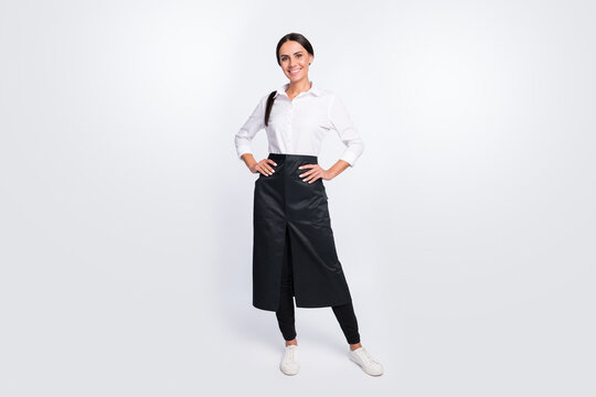 Full length body size photo of confident waitress wearing black apron isolated on white color background