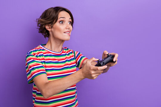 Profile photo of nervous person hold controller play games biting lips tryhard isolated on violet color background
