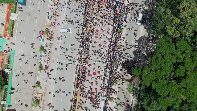 Aerial top of drummers performing amidst crowd during immersion of lord ganesha