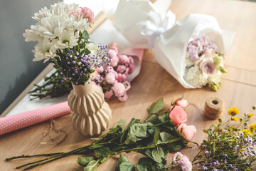 Florist at work. Woman making autumn floral decorations
