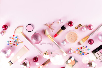Festive make up products border on pink background