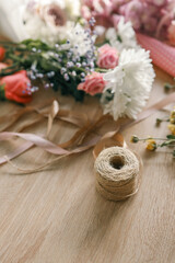 Obraz na płótnie Canvas Florist workplace, flowers and craft thread