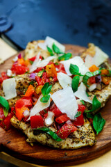 Chicken bruscetta  with vegetables cooking on an outdoor grill