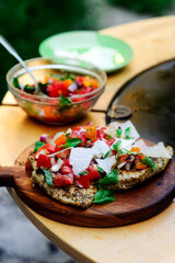 Chicken bruscetta  with vegetables cooking on an outdoor grill