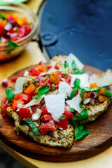 Chicken bruscetta  with vegetables cooking on an outdoor grill