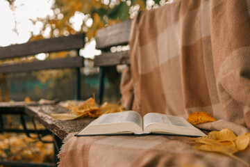 Open Bible on a blanket, autumn