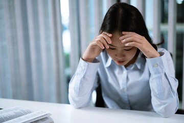 Alone Working Late. Asian business woman at workplace in office  laid her head down on the table fell asleep in front of laptop