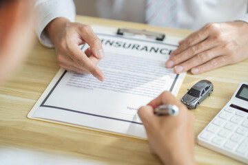 Loss Adjuster Insurance Agent Inspecting Damaged Car. .Sales manager giving advice application form document considering mortgage loan offer for car &nbsp;insurance