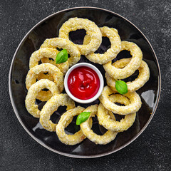 onion rings deep fryer tomato sauce fast food eating cooking meal food snack on the table copy space food background rustic top view