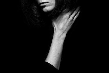 Home violence concept. Close up portrait of young woman hiding face posing with hand on neck...
