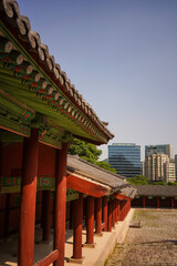 Contrast between old traditional korean palace and modern skyscrapers in the background