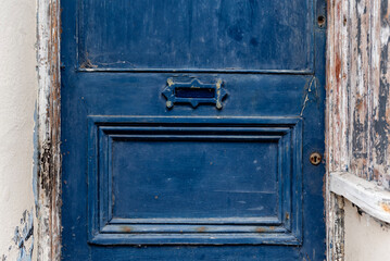 Old blue door with small letterbox