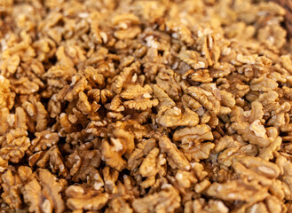 Closeup of Peeled Walnuts Pile. Many Different Textured Walnuts. Walnuts Background. Selling shelled nuts at the market