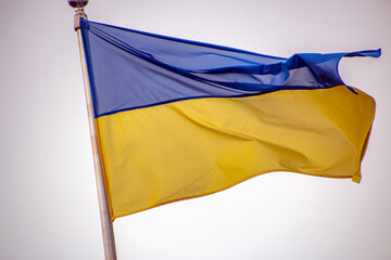 Ukrainian flag flutters in the wind against the sky