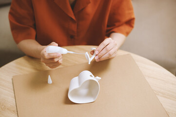 Hands of unrecognizable person fixing broken coffee cup