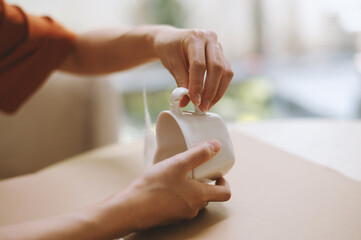 Creative person fixing broken porcelain tea cup