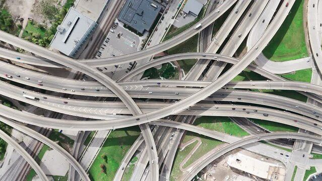 Drone top down shot on famous road intersection with traffic on multiple flyovers.